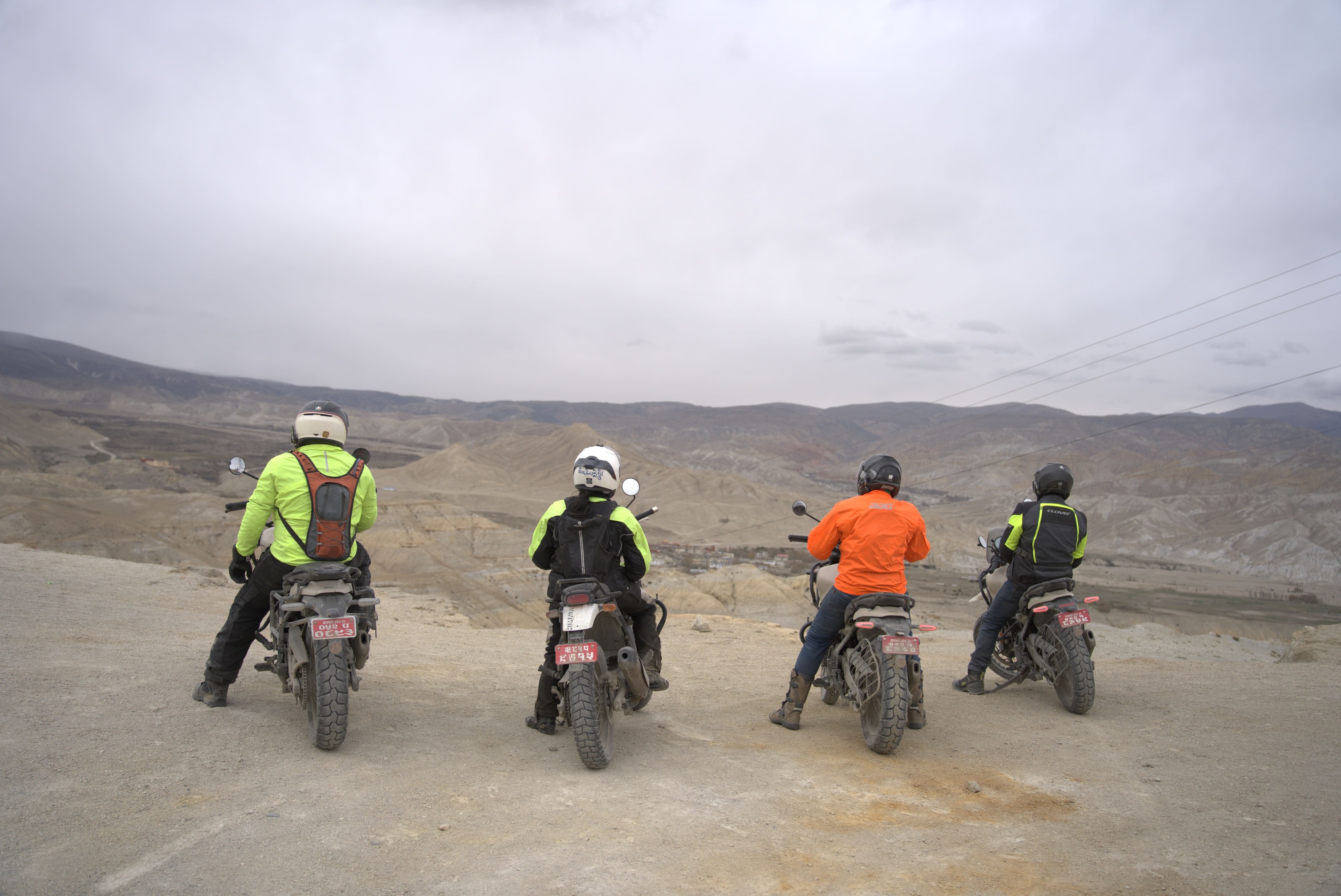 4 riders posing at Lomanthang on their upper mustang motorbike tour
